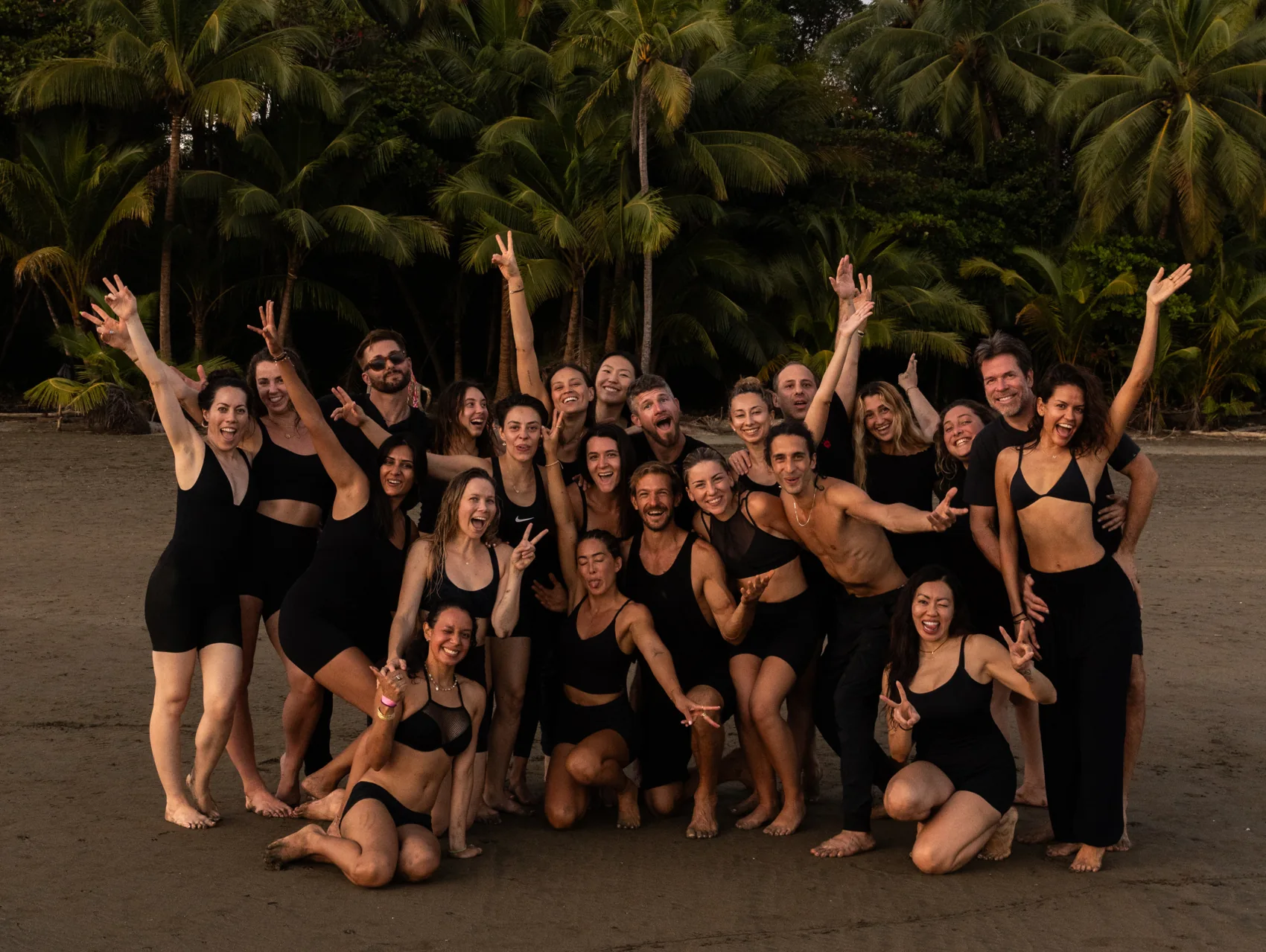 A retreat group on the beach at dusk