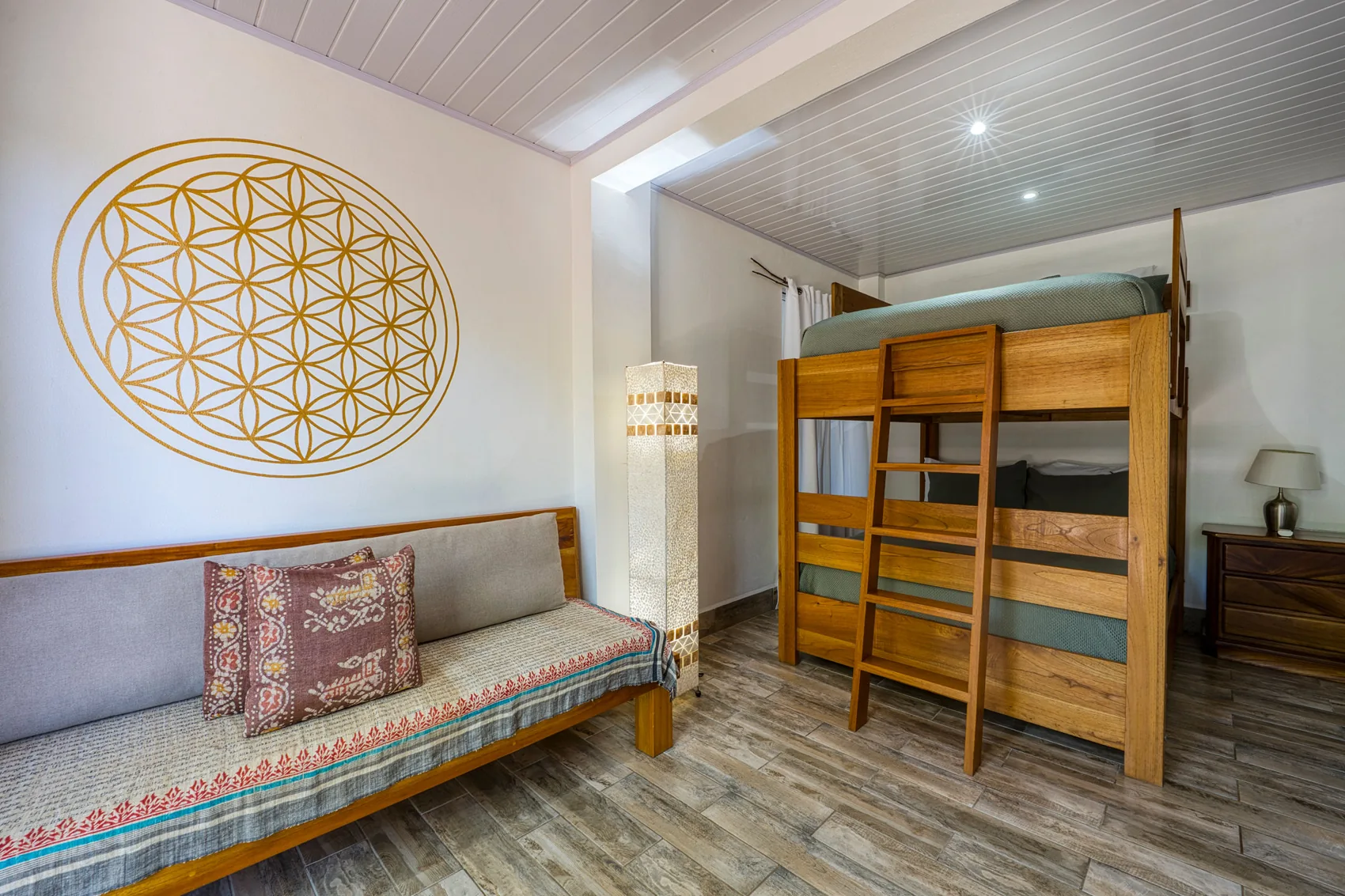 Flower of Life: bunk beds under a gold mural