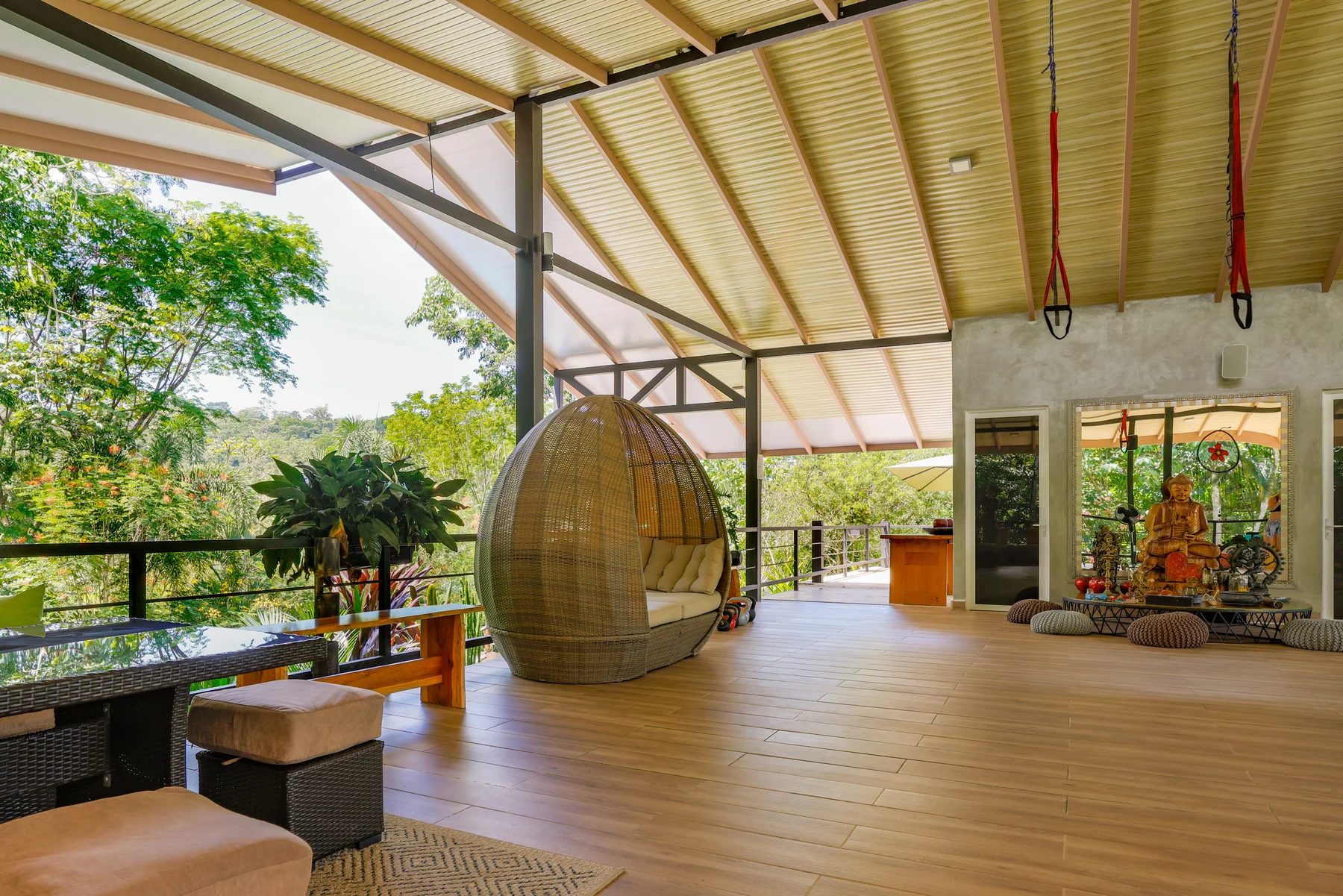 Sunlight across the open-air Yoga Chalet and its garden-facing lounge